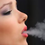 girl is smoking an e-cigarette