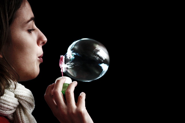 Girl blowing soap bubble