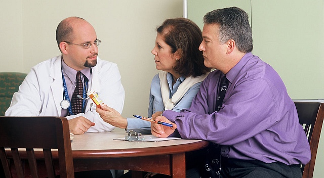 a doctor and couple are talking