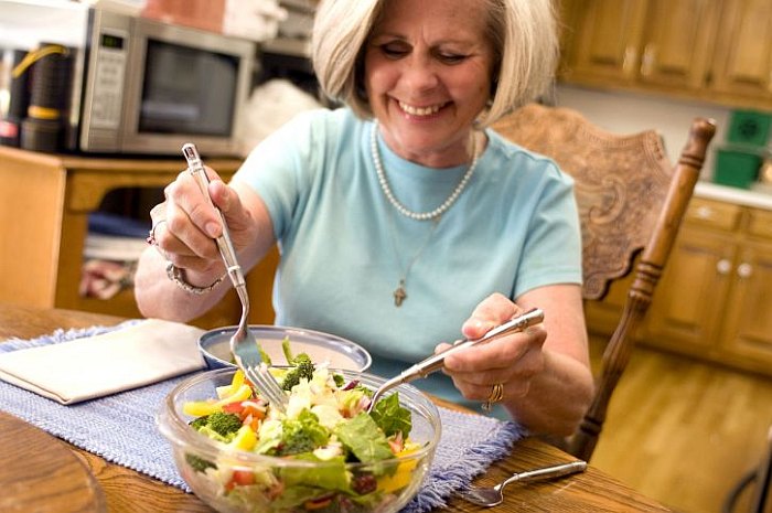 older woman eating salad