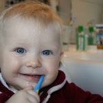 cute kid brushing teeth